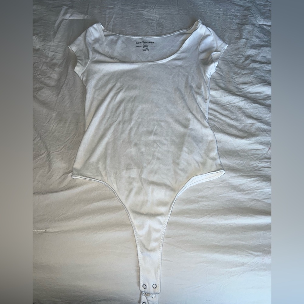 White Calvin Klein bodysuit.